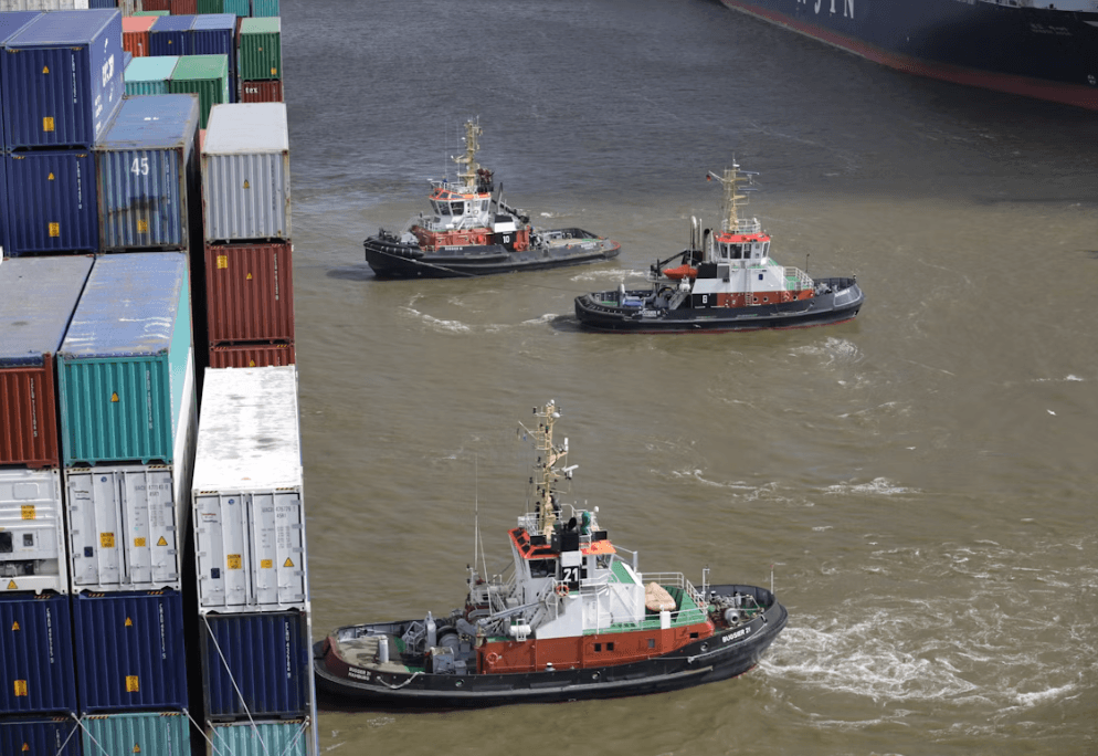 Commercial tugboat assisting a barge on open water